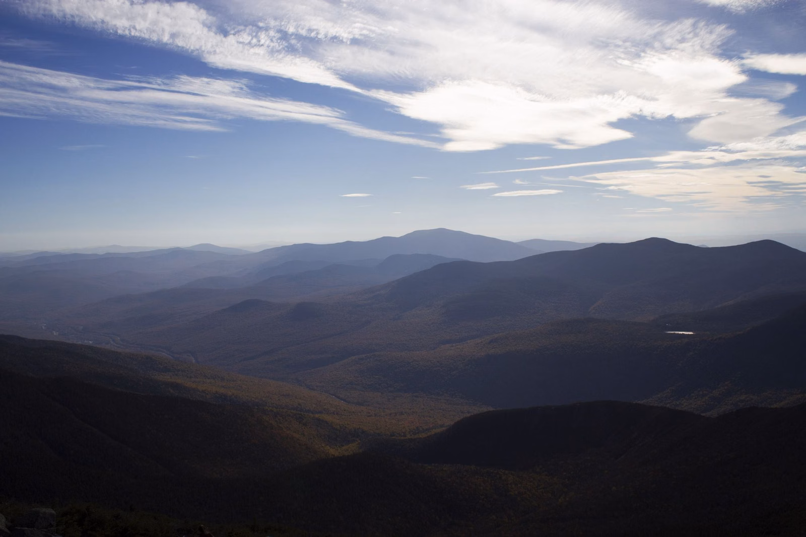 Layered blue mountains and forested valleys seen from high above Franconia Notch