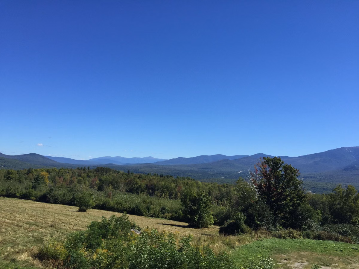 Franconia Ridge on the skyline across open fields seen from Sugar Hill